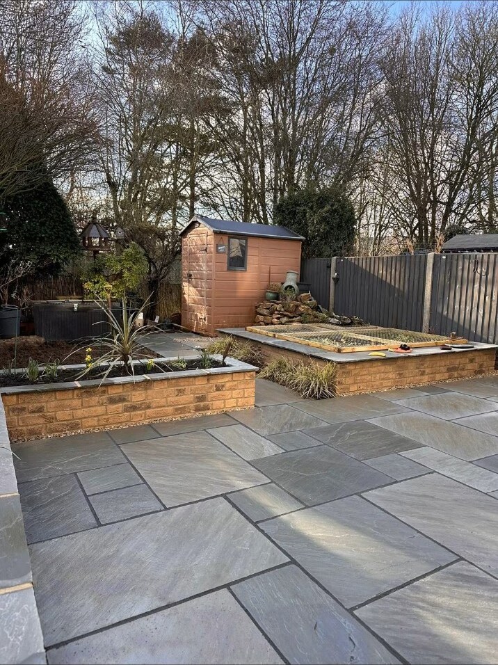 Completed sandstone patio and raised beds
